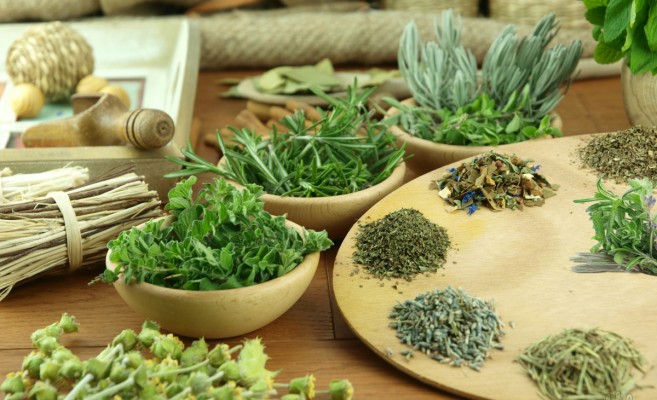 Herbs and spices on a wooden background